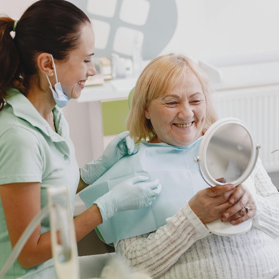 Doctor shows patient their new smile in the mirror after dermal filler and cosmetic treatment at Arizona Smiles in Gilbert, AZ.